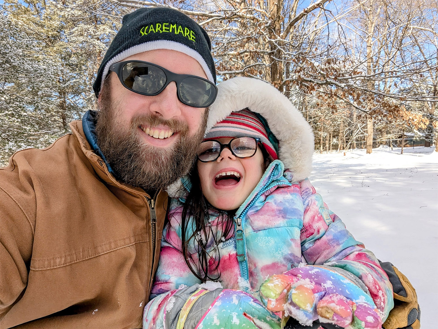 Eli and EmmaGrace playing in the snow, both laughing