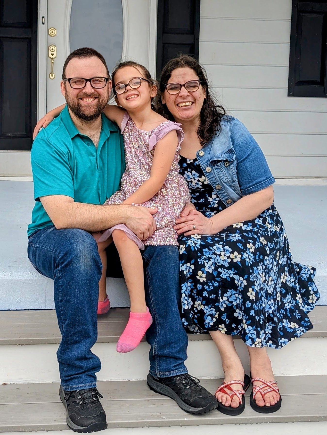 Eli, Sarah, and EmmaGrace together on their porch